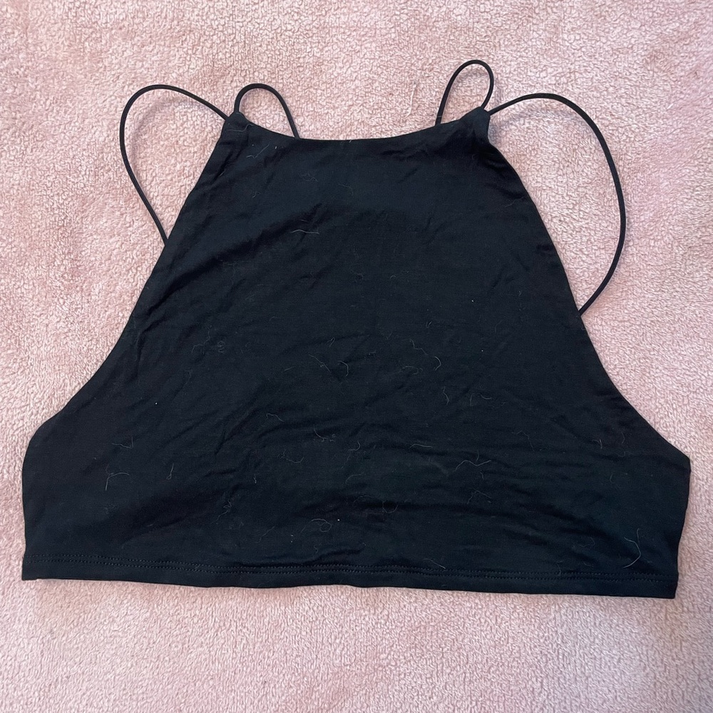 Super cute black halter tank with strappy back. Perfect for going out.